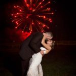 red fireworks at night with couple