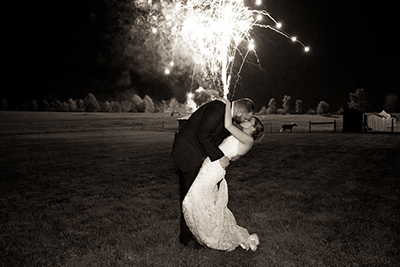 black and white wedding portrait with fireworks