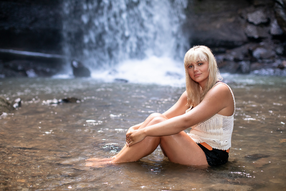 Portrait of a young girl by waterfalls