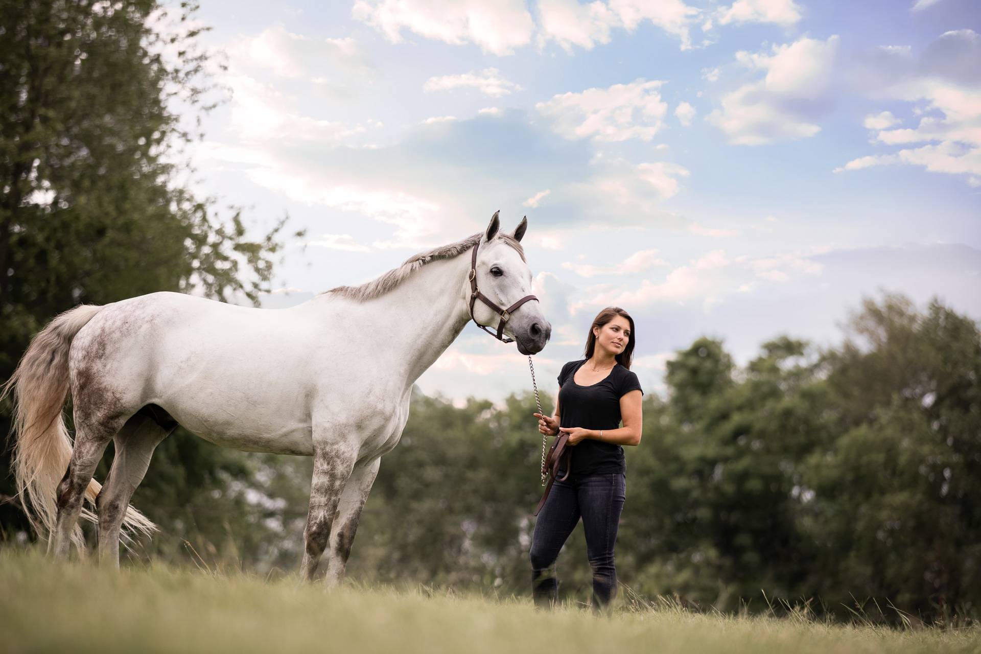 Woman and her horse with blue skies